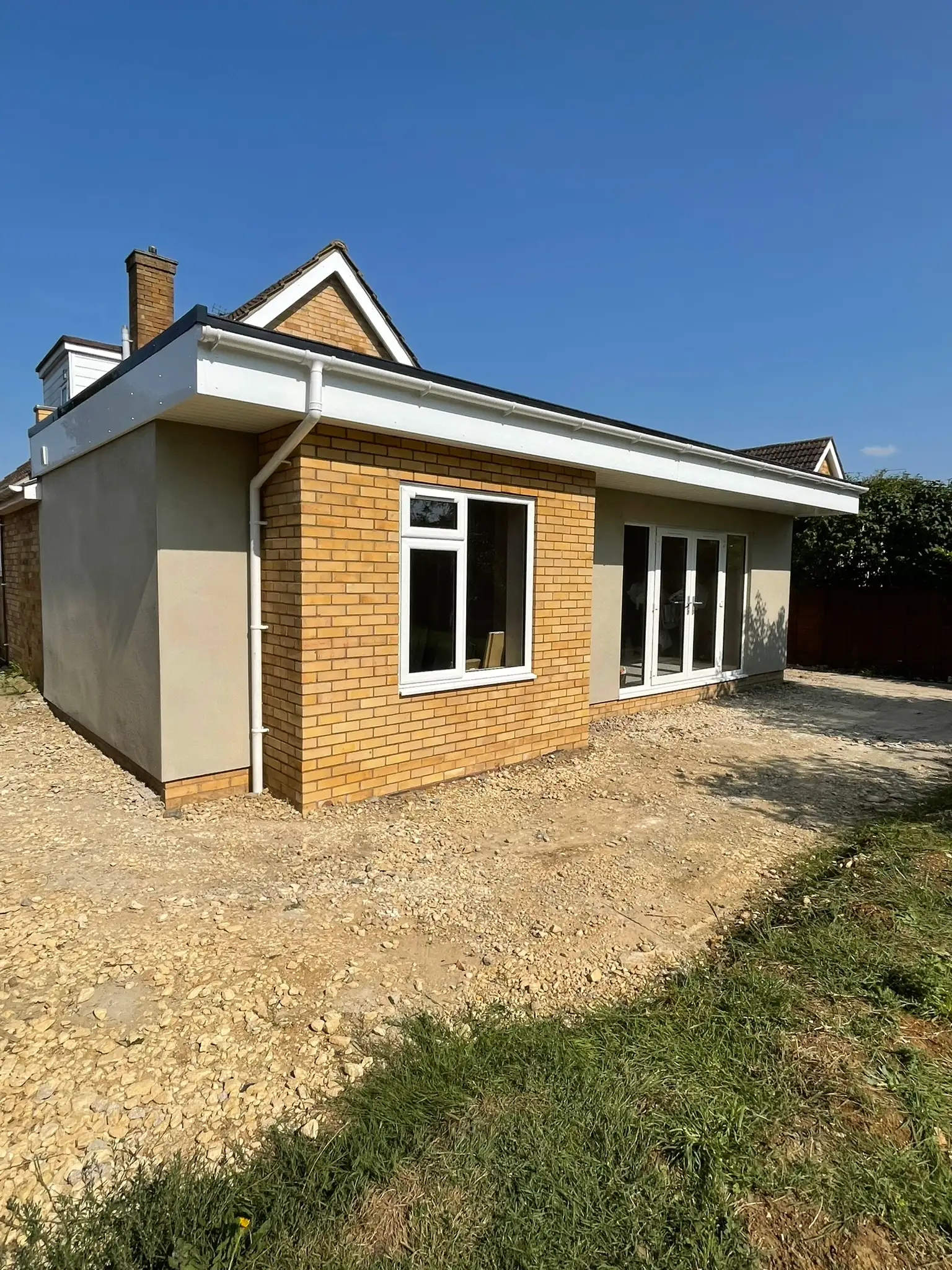 Brick extension under construction with render going on